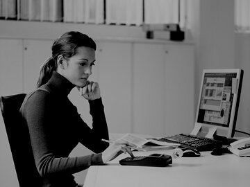 female accountant in blue sweater using calculator